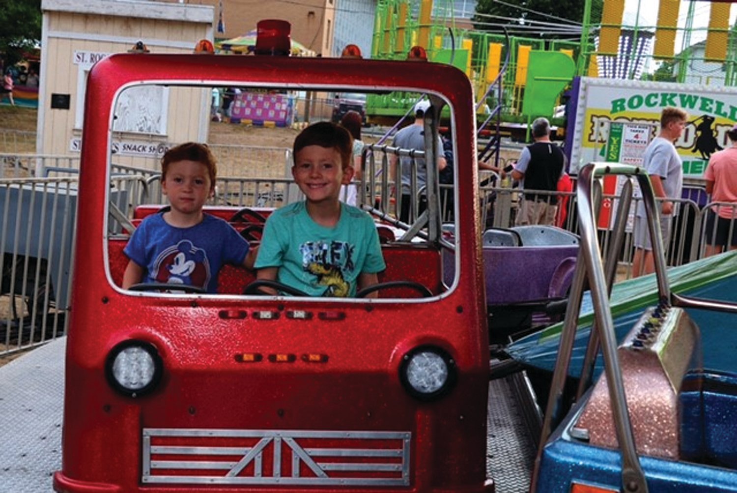 RIDING TOGETHER: Julian and Oliver Matos of Warwick, grandsons of St. Rocco Holy Name Society member, James Lanzi, enjoyed a ride at the feast.